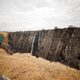 Visitors walk over a bridge as dry cliffs are seen along the parched gorge on the Zambian side of Victoria Falls, Zambia, following a prolonged drought, Dec. 5, 2019.